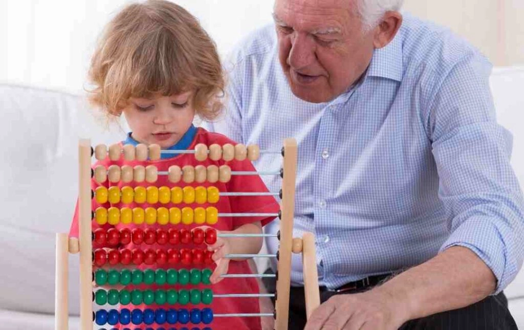 child using abacus with an old man