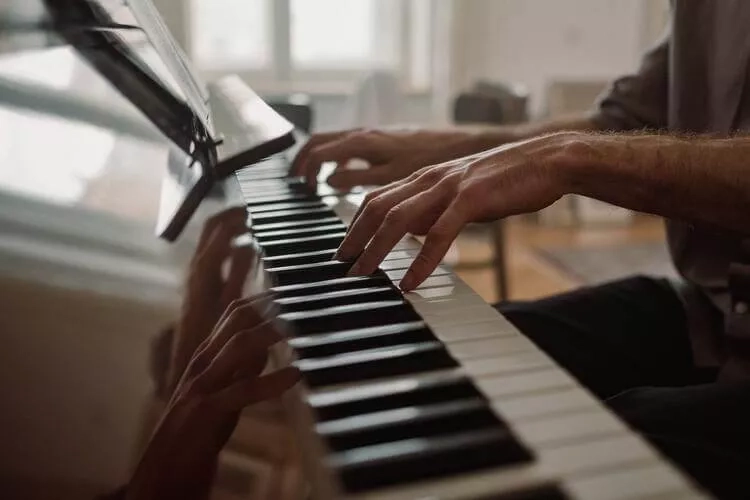 playing piano with both hands